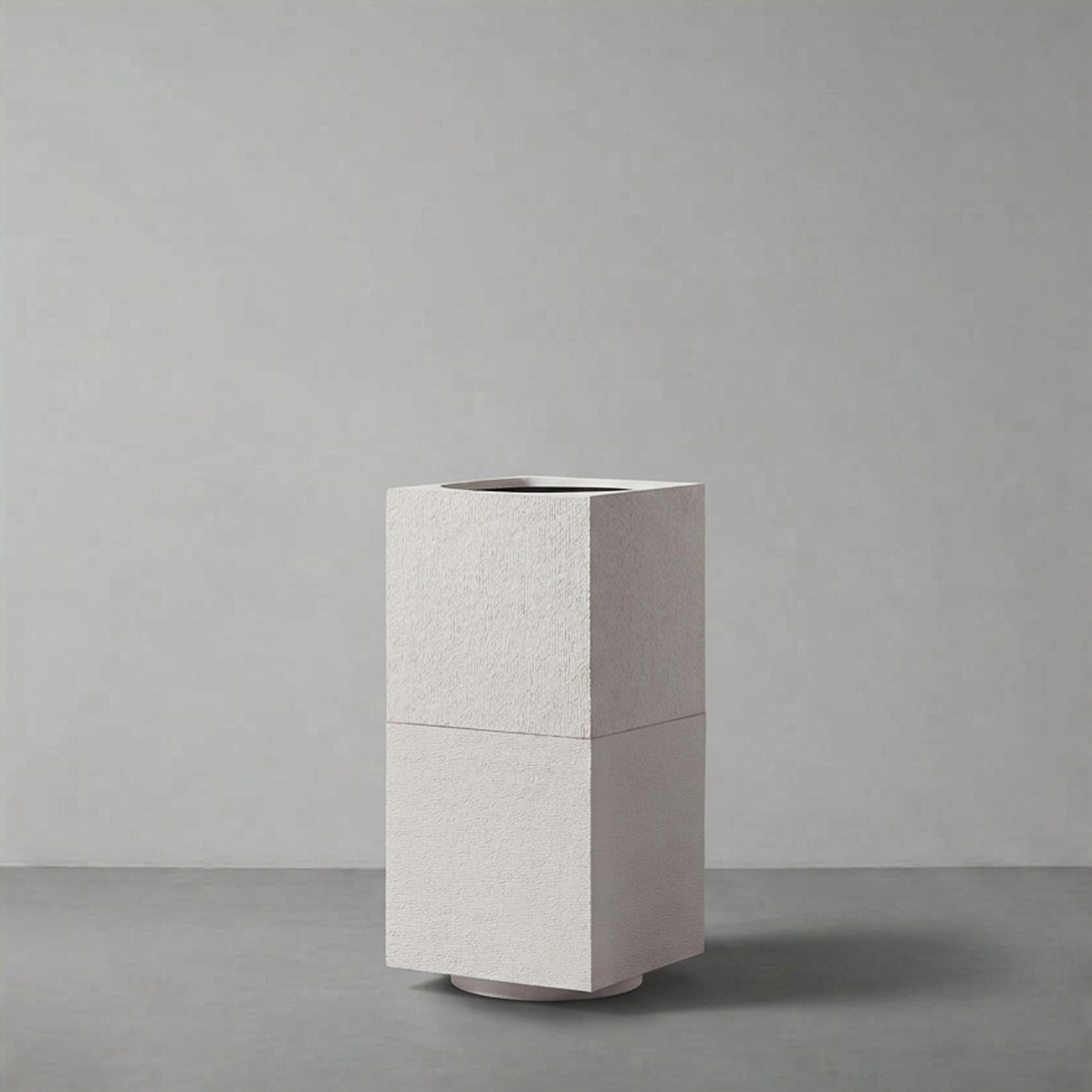 Apollo II in Alabaster, a two-segment stone-textured column, on a plain grey studio backdrop