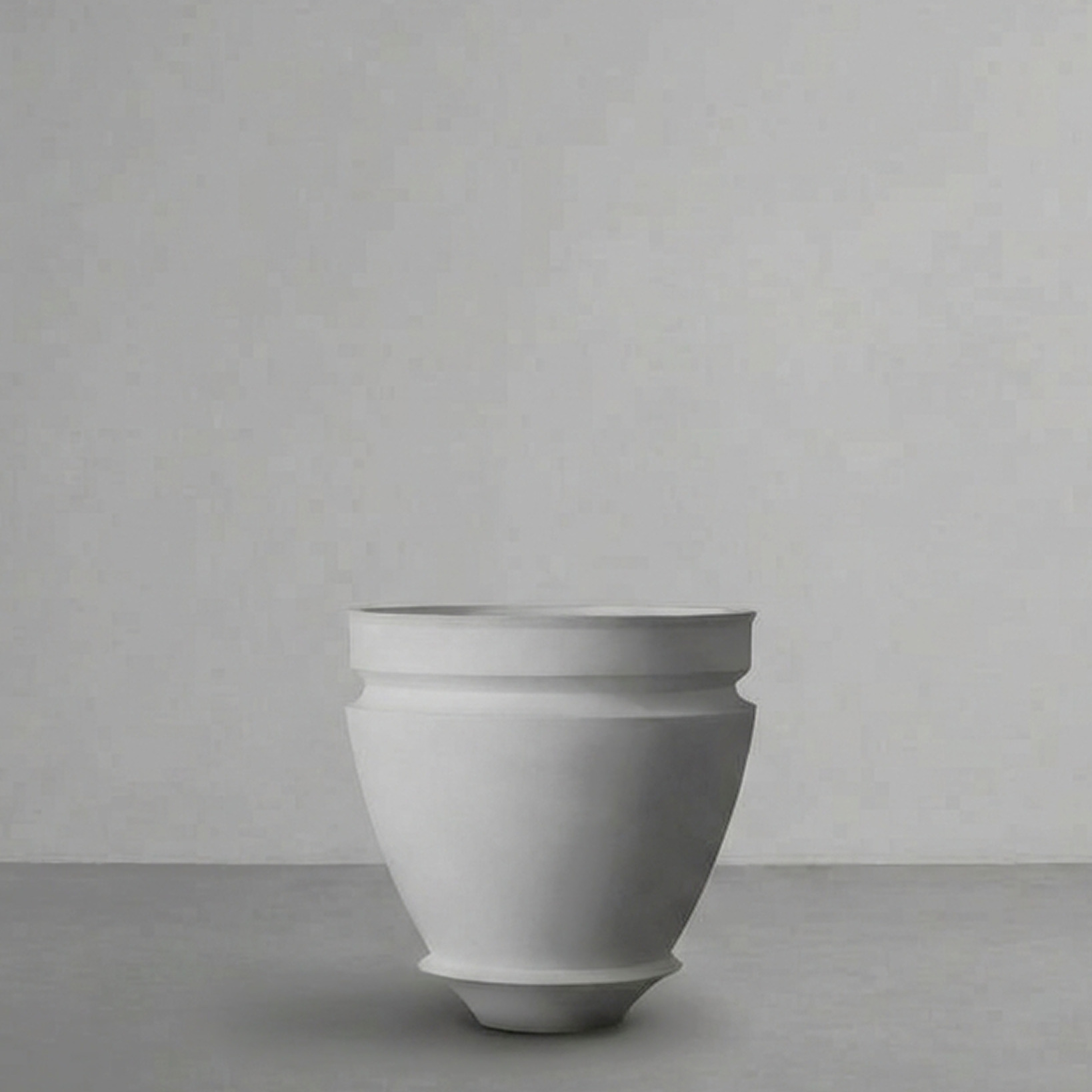 Artifact 07 in Alabaster, a wide deep bowl, on a grey studio backdrop