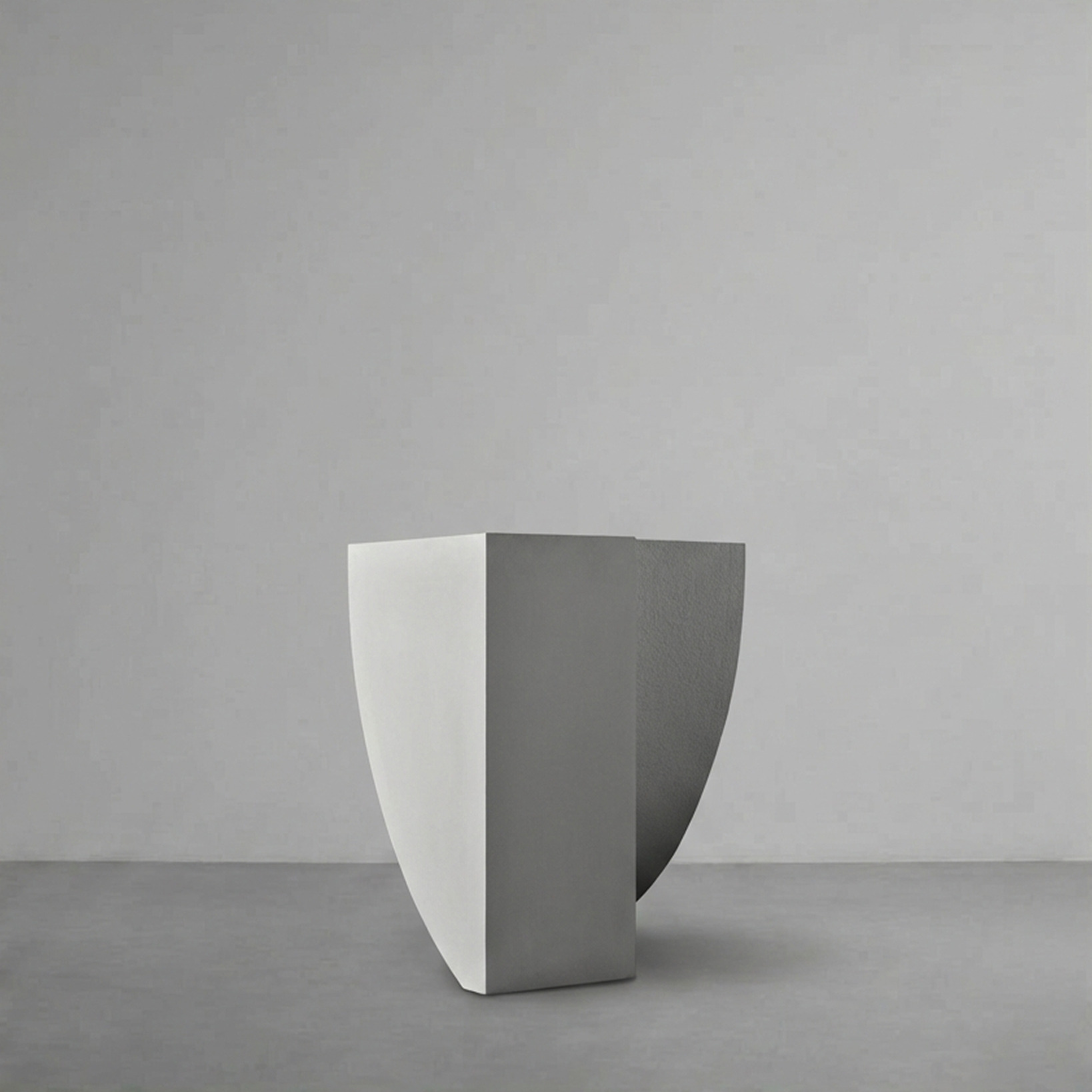 Icarus 01 in Alabaster, a curved sail-like planter, on a grey studio backdrop