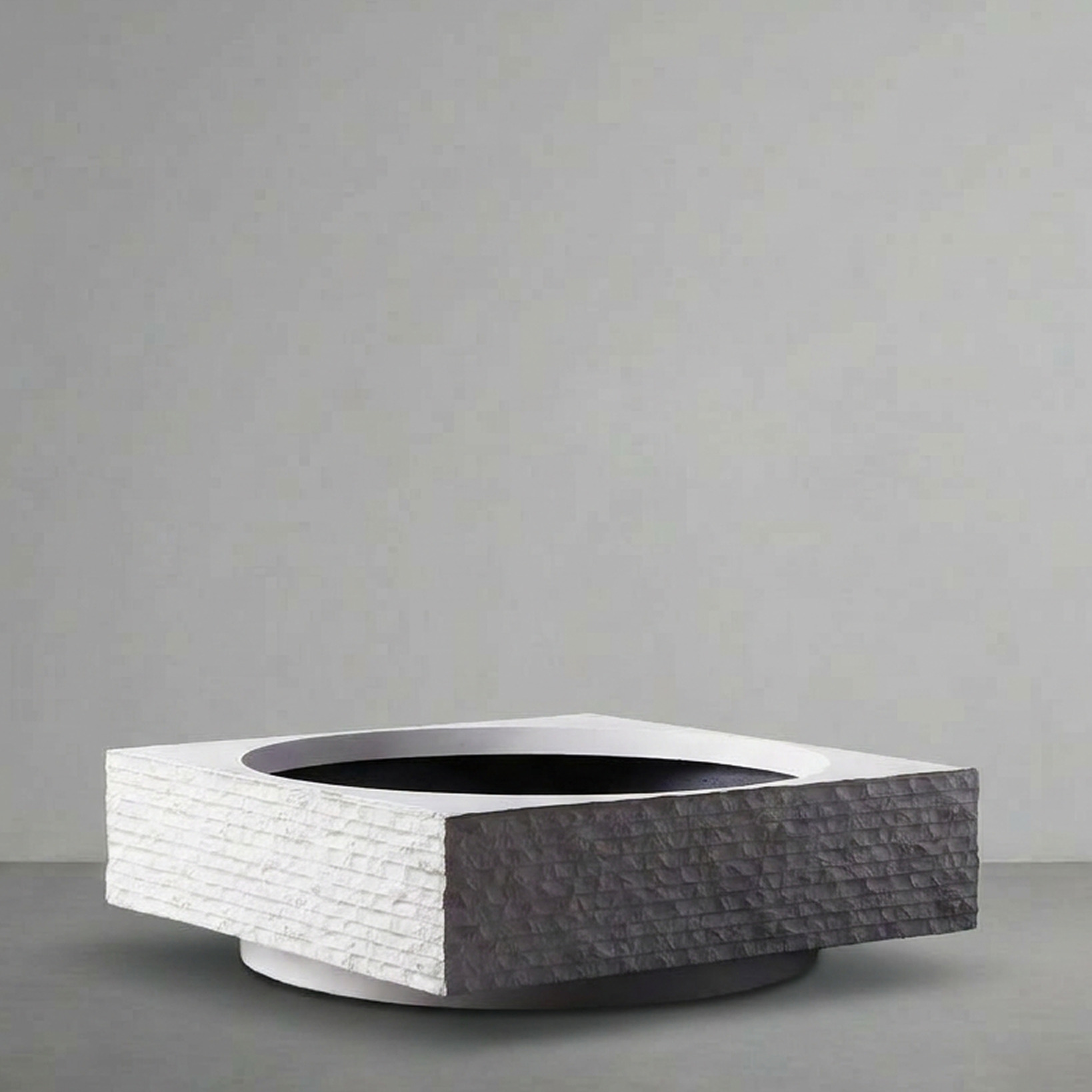 Janus I, a low rectangular trough split white and charcoal, on a grey studio backdrop