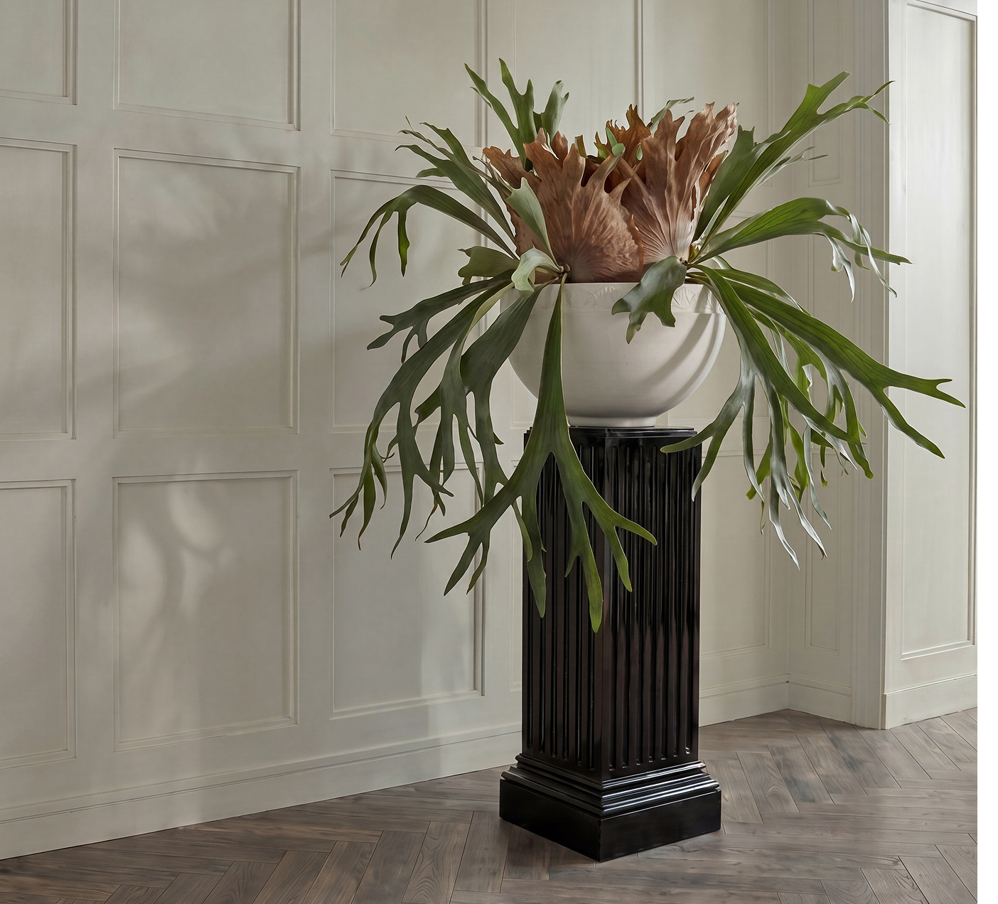 Orion I planted with a staghorn fern and protea on a dark plinth